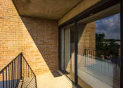 Thumbnail 18 of 27 - large balcony with sliding doors to inside of apartment at washington view apartments in south east washington dc
