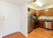 Thumbnail 16 of 27 - renovated kitchen with stainless steel appliances and hardwood flooring at washington view apartments in southeast dc