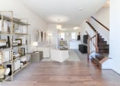 Thumbnail 5 of 14 - view of large living area with sofa, sitting area, bookshelves and staircase at sheridan station south townhomes in washington dc
