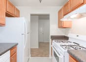 Thumbnail 5 of 17 - kitchen with gas range, wood cabinetry and energy efficient appliances at whitelaw apartments in washington dc