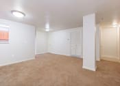 Thumbnail 9 of 17 - vacant living area with plush carpeting, and view of kitchen at whitelaw apartments in washington dc