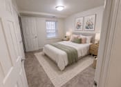 Thumbnail 6 of 21 - A bedroom with a bed, nightstand, and two pictures on the wall.