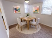 Thumbnail 7 of 21 - A dining room with a round table and chairs.