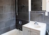 Thumbnail 7 of 29 - A white bathroom sink with a white tub and a white cabinet.