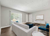 Thumbnail 36 of 52 - A living room with a couch and chairs and a table at Pines at Lawrenceville Decatur 30033