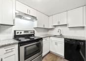 Thumbnail 38 of 52 - Upgraded kitchen with white cabinets and stainless steel appliances at Pines at Lawrenceville Decatur 30033