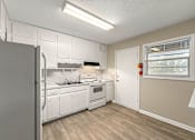 Thumbnail 6 of 32 - Spacious kitchen with white appliances at Balfour 296, Lilburn, Georgia 30047