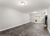 Thumbnail 9 of 19 - the spacious living room with hardwood floors at the whispering winds apartments in pearland, tx  at Balfour 296, Georgia, 30047