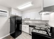 Thumbnail 4 of 19 - a kitchen with white cabinets and black appliances  at Balfour 296, Georgia, 30047