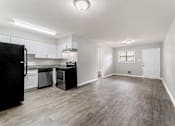 Thumbnail 3 of 19 - an empty living room with a kitchen in the background  at Balfour 296, Lilburn, 30047