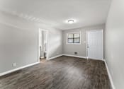 Thumbnail 10 of 19 - a bedroom with hardwood floors and grey walls  at Balfour 296, Georgia, 30047