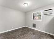 Thumbnail 5 of 19 - a bedroom with hardwood floors and grey walls  at Balfour 296, Lilburn, GA