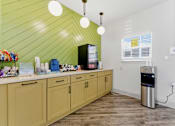 Thumbnail 48 of 75 - A kitchen with wooden cabinets and a green wall.