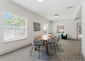 Thumbnail 41 of 75 - A dining room with a wooden table and chairs.