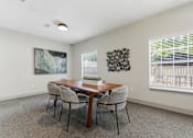 Thumbnail 40 of 75 - A dining room with a wooden table and chairs.