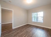 Thumbnail 32 of 35 - an empty living room with wood flooring and a window at Crogman School Lofts, Atlanta Georgia