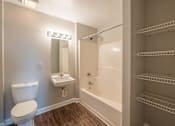 Thumbnail 31 of 35 - a bathroom with a toilet and a tub and a sink at Crogman School Lofts, Georgia, 30315