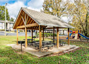 Thumbnail 52 of 75 - Wooden pavilion with a picnic tables at Eastlake Gardens in Decatur, Georgia 30032.