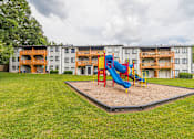 Thumbnail 8 of 35 - Playground with blue slide at Pinewood Townhomes, Tucker, GA