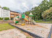 Thumbnail 15 of 35 - Playground with green slide at Pinewood Townhomes, Tucker