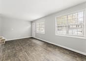Thumbnail 26 of 35 - Bright room with window and wooden floor at Pinewood Townhomes, Tucker, GA