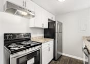 Thumbnail 27 of 35 - Kitchen with black stove at Pinewood Townhomes, Tucker