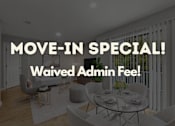 Thumbnail 33 of 33 - A dining room with a glass table and chairs, and a sign that reads "MOVE-IN SPECIAL! Waived Admin Fee!"