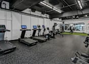 Thumbnail 45 of 47 - A gym with treadmills and other exercise equipment.