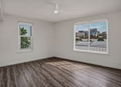Thumbnail 16 of 34 - A room with a window and a picture of a cityscape on the wall.