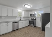 Thumbnail 2 of 28 - an empty kitchen with white cabinets and stainless steel appliances