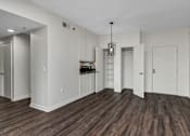 Thumbnail 25 of 34 - A room with white walls and wooden flooring.
