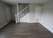 Thumbnail 37 of 39 - A room with a staircase and white doors.