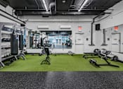 Thumbnail 41 of 47 - A gym with a green floor and white walls.