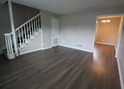Thumbnail 35 of 39 - A room with a staircase and wooden flooring.