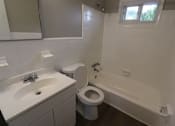 Thumbnail 38 of 39 - A white sink and toilet in a bathroom.