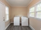 Thumbnail 24 of 30 - A laundry room with a washer and dryer.
