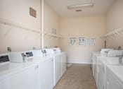 Thumbnail 12 of 25 - A laundromat with washers and dryers.