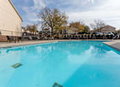 Thumbnail 11 of 25 - A large swimming pool with a blue tinted water.