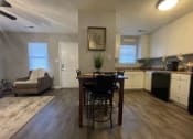 Thumbnail 7 of 27 - a kitchen and a living room with a table and chairs