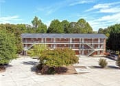 Thumbnail 15 of 27 - an image of a building with trees in front of it