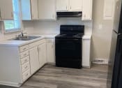 Thumbnail 28 of 30 - a kitchen with a stove a sink and a refrigerator