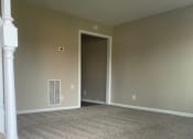 Thumbnail 29 of 30 - an empty room with a stairway and a doorway