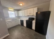 Thumbnail 21 of 27 - a kitchen with white cabinets and a black refrigerator