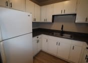 Thumbnail 10 of 29 - an empty kitchen with white cabinets and a refrigerator