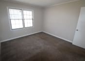 Thumbnail 14 of 29 - a carpeted room with a window and a door