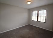 Thumbnail 6 of 29 - an empty living room with a window and carpet