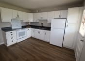 Thumbnail 1 of 29 - a kitchen with white cabinets and a white stove and refrigerator