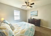 Thumbnail 8 of 27 - the master bedroom has a large bed and a ceiling fan