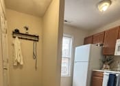 Thumbnail 22 of 25 - A white refrigerator is in a kitchen with wood floors.