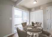 Thumbnail 21 of 37 - a dining room with a table and chairs